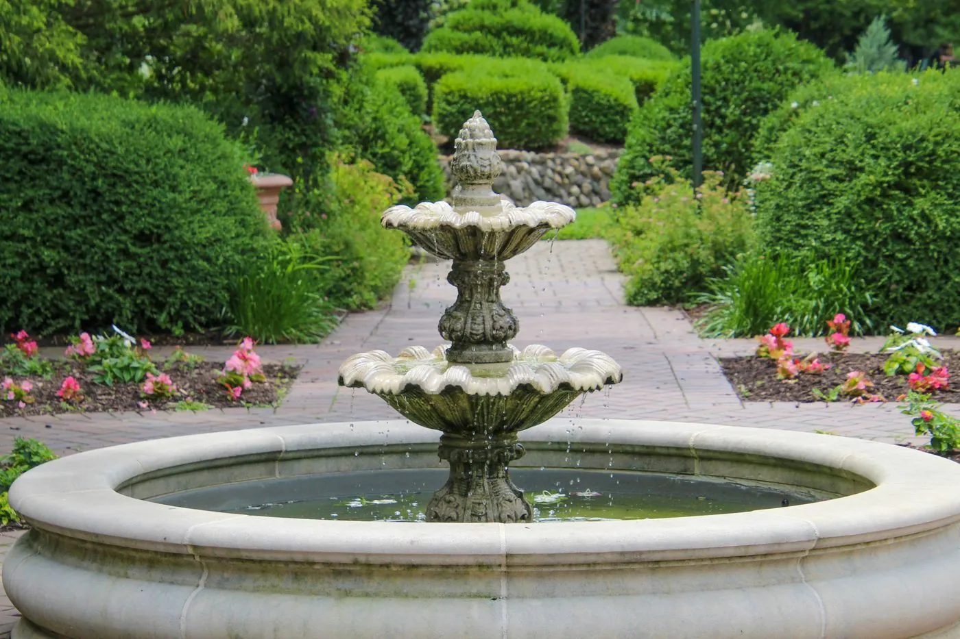 Stone waterfall and reflecting pool in a landscaped UAE villa garden at dusk, built by Absher Landscaping